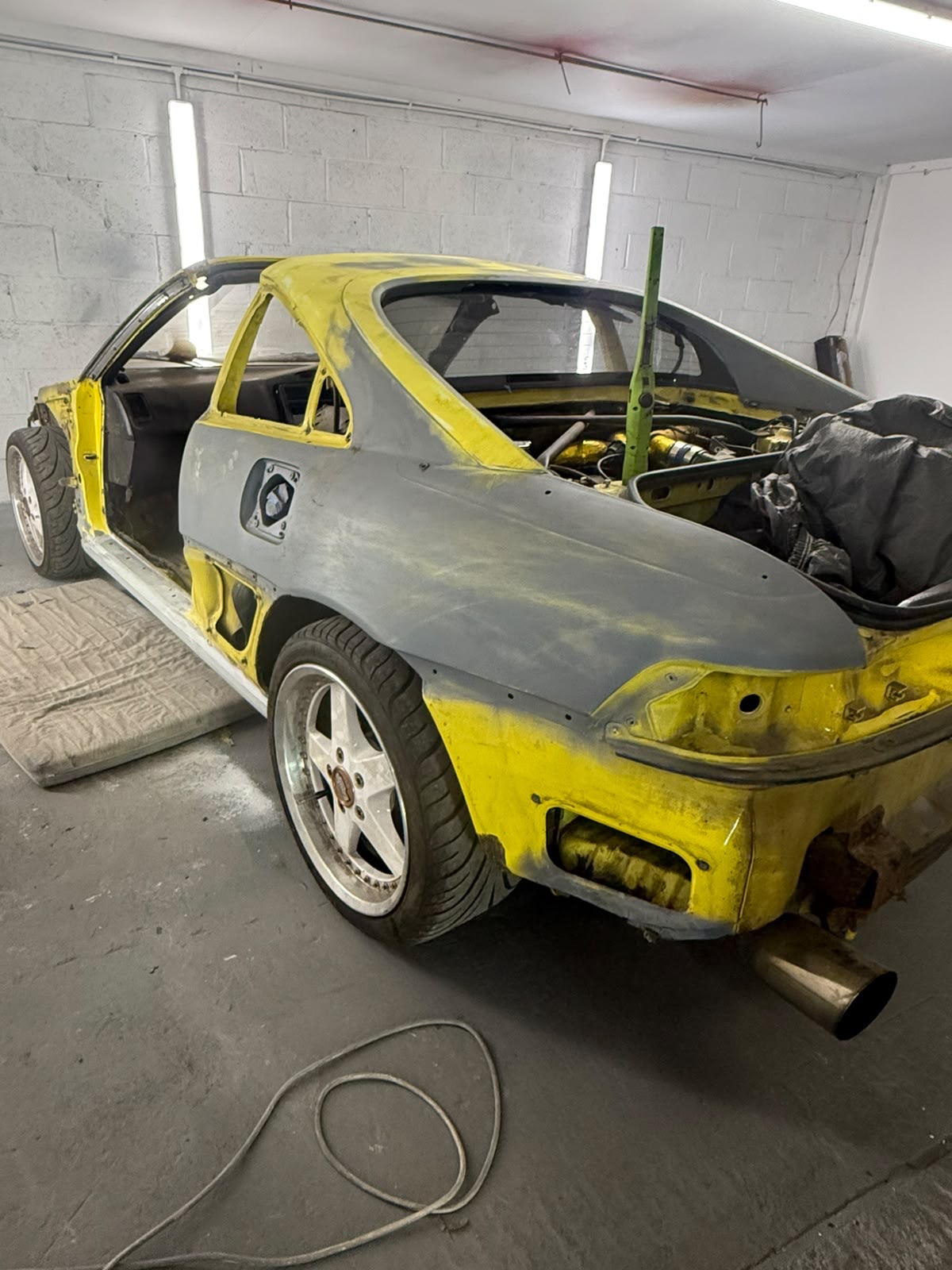 Before — Panels prepared and masked ahead of a full respray, refinished in a bright yellow with a fresh, even gloss.