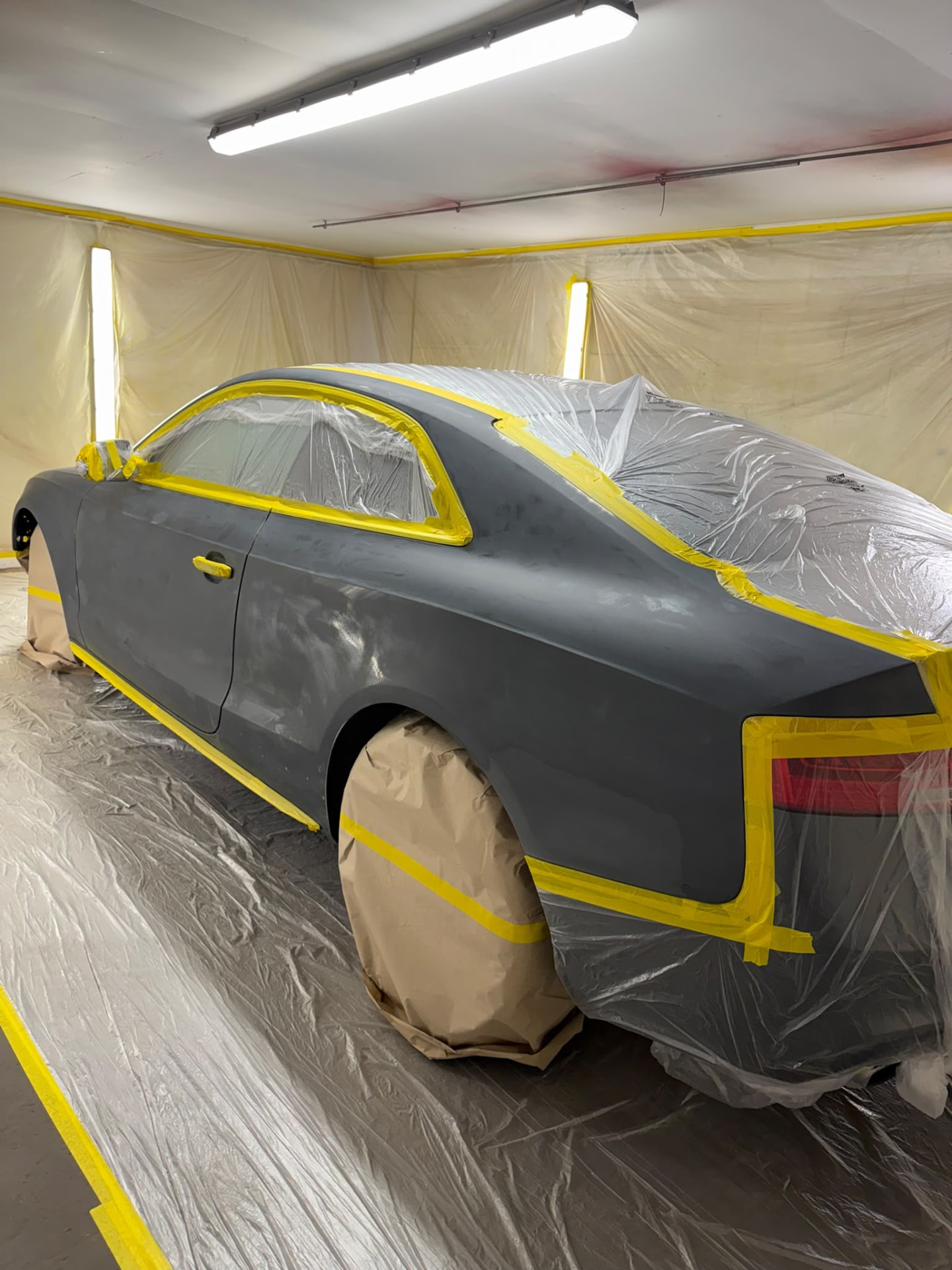 Before 7 — Audi bodywork shown through damage repair, preparation, masking, primer and paintwork.