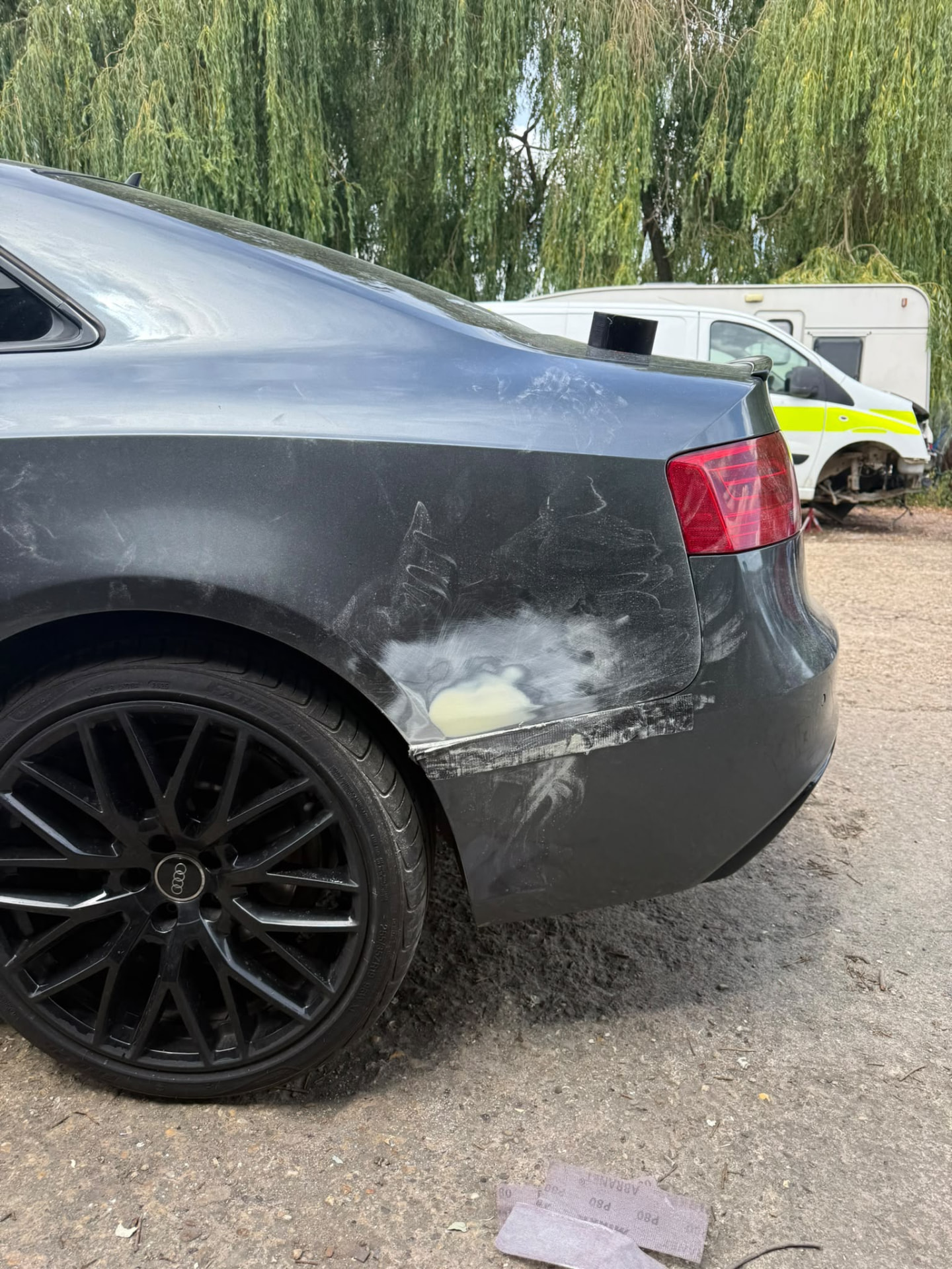 Before — Audi bodywork shown through damage repair, preparation, masking, primer and paintwork.